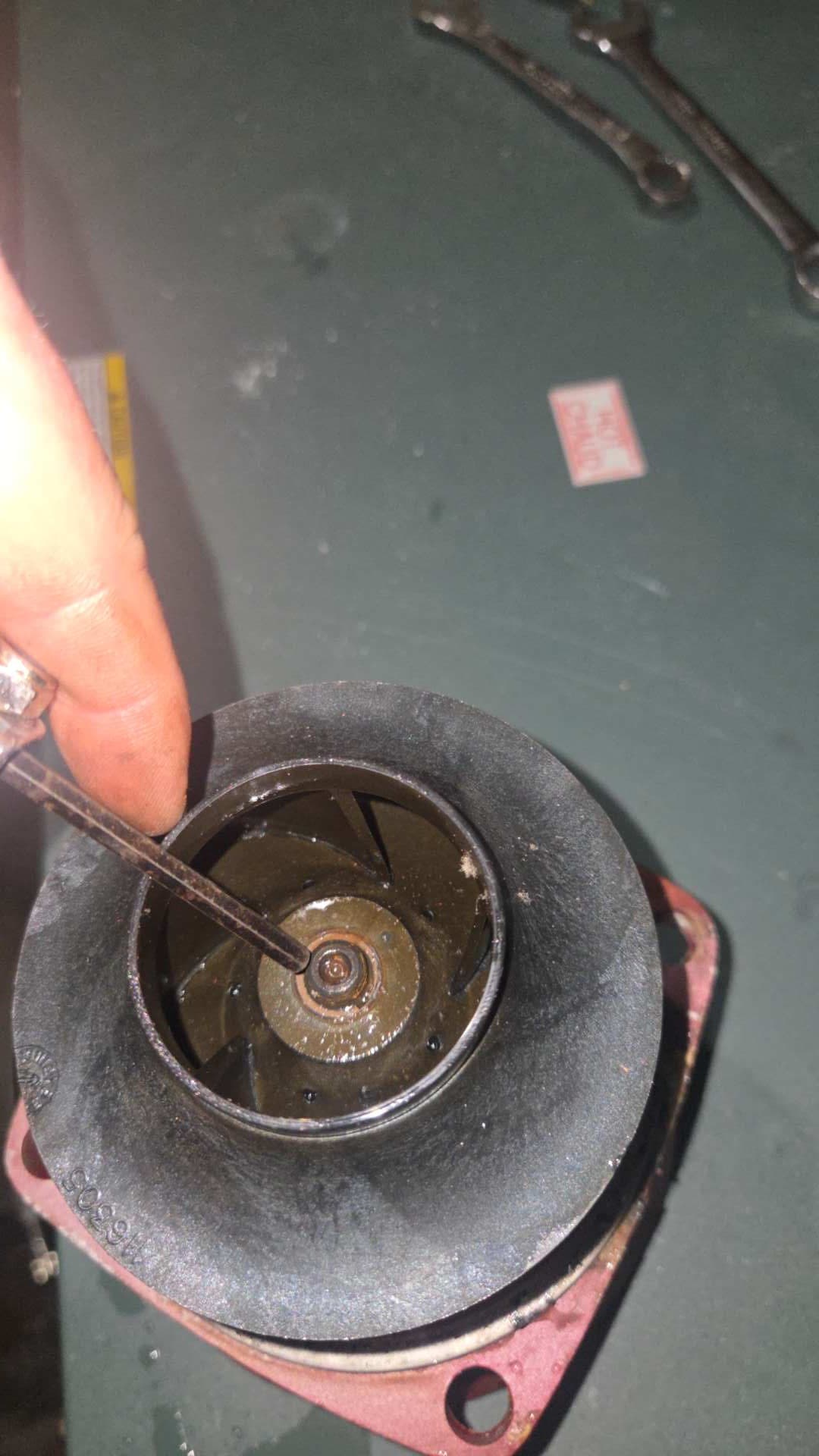 Boiler circulation pump impeller being inspected during the repair