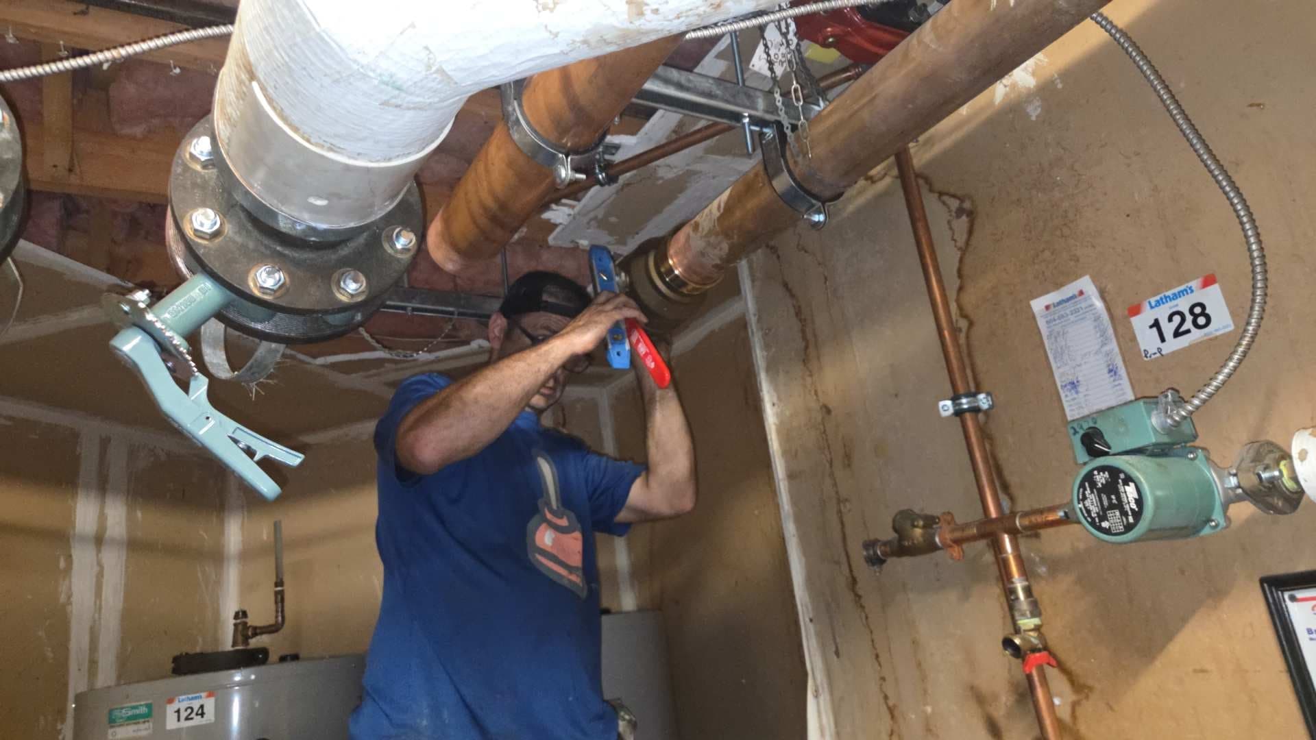Technician completing a mechanical-room pipe repair