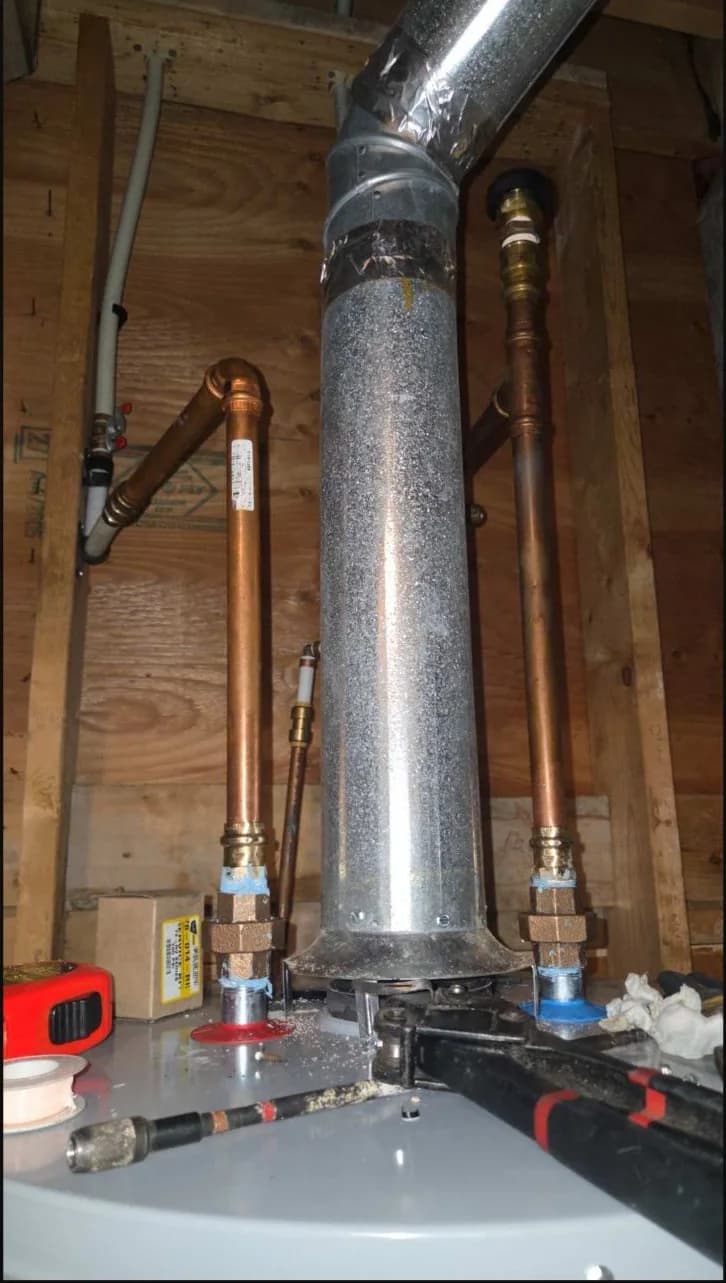 Water and vent connections above the replacement water heater