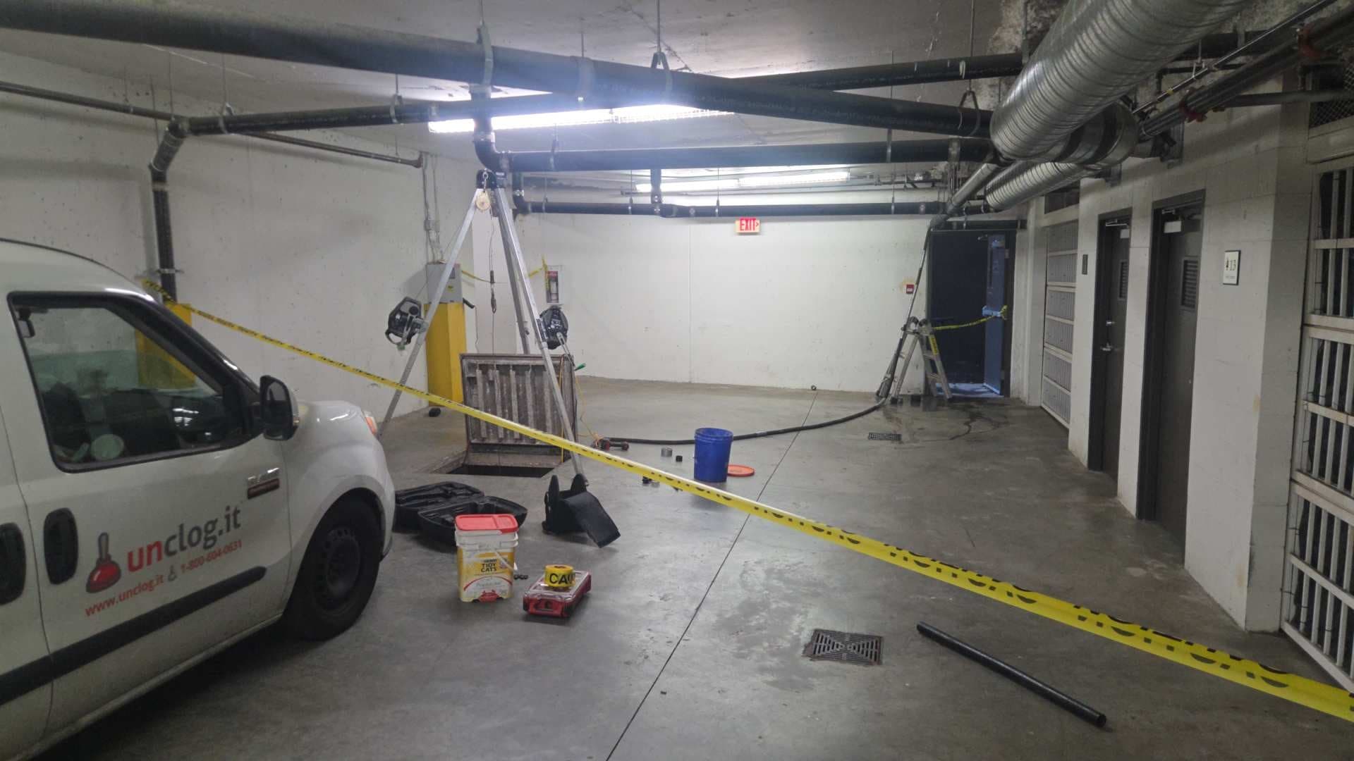 Barricaded work area around the open sump vault in a parking garage