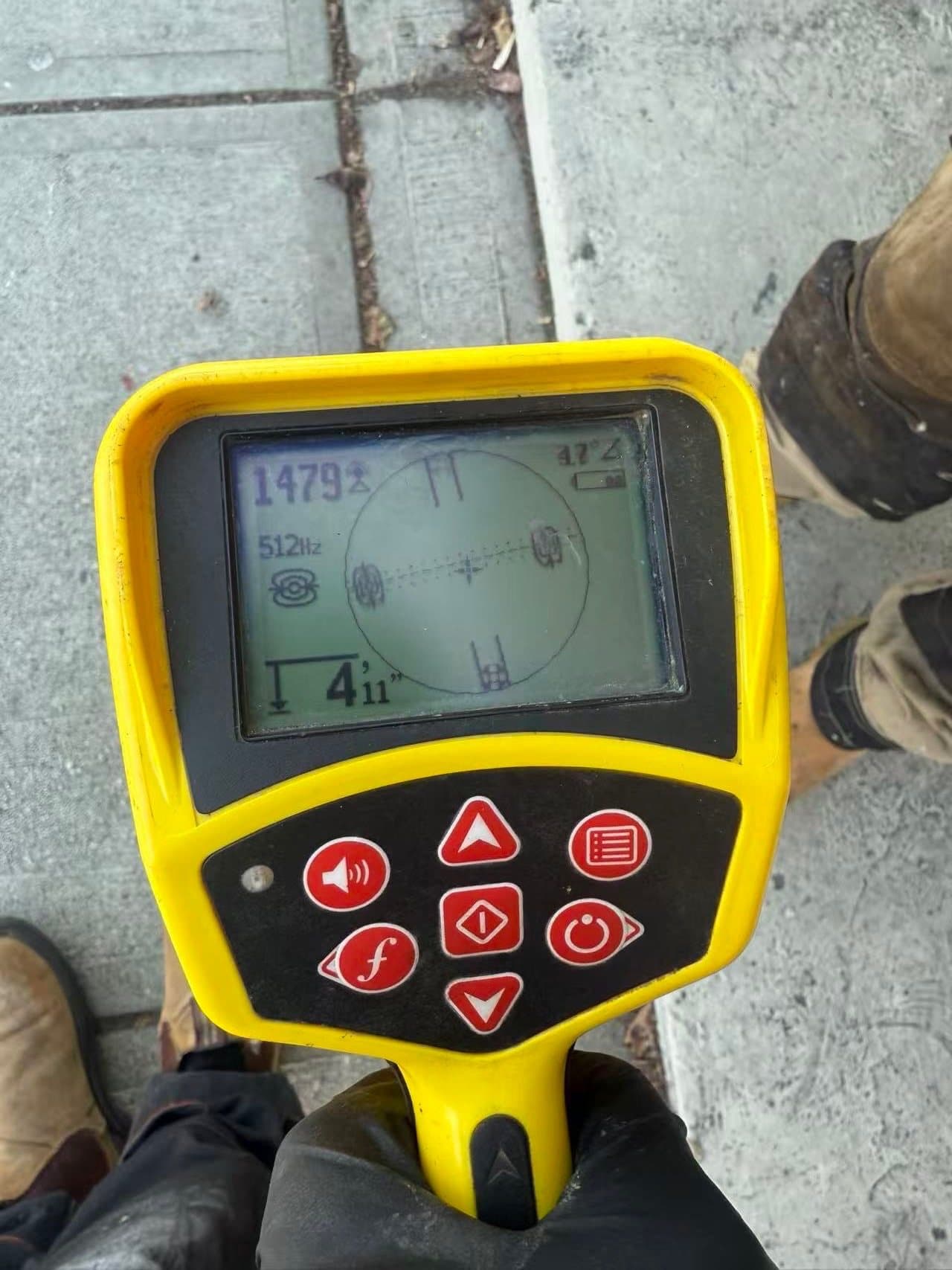 Electronic line locator showing the measured location of a drain investigation point