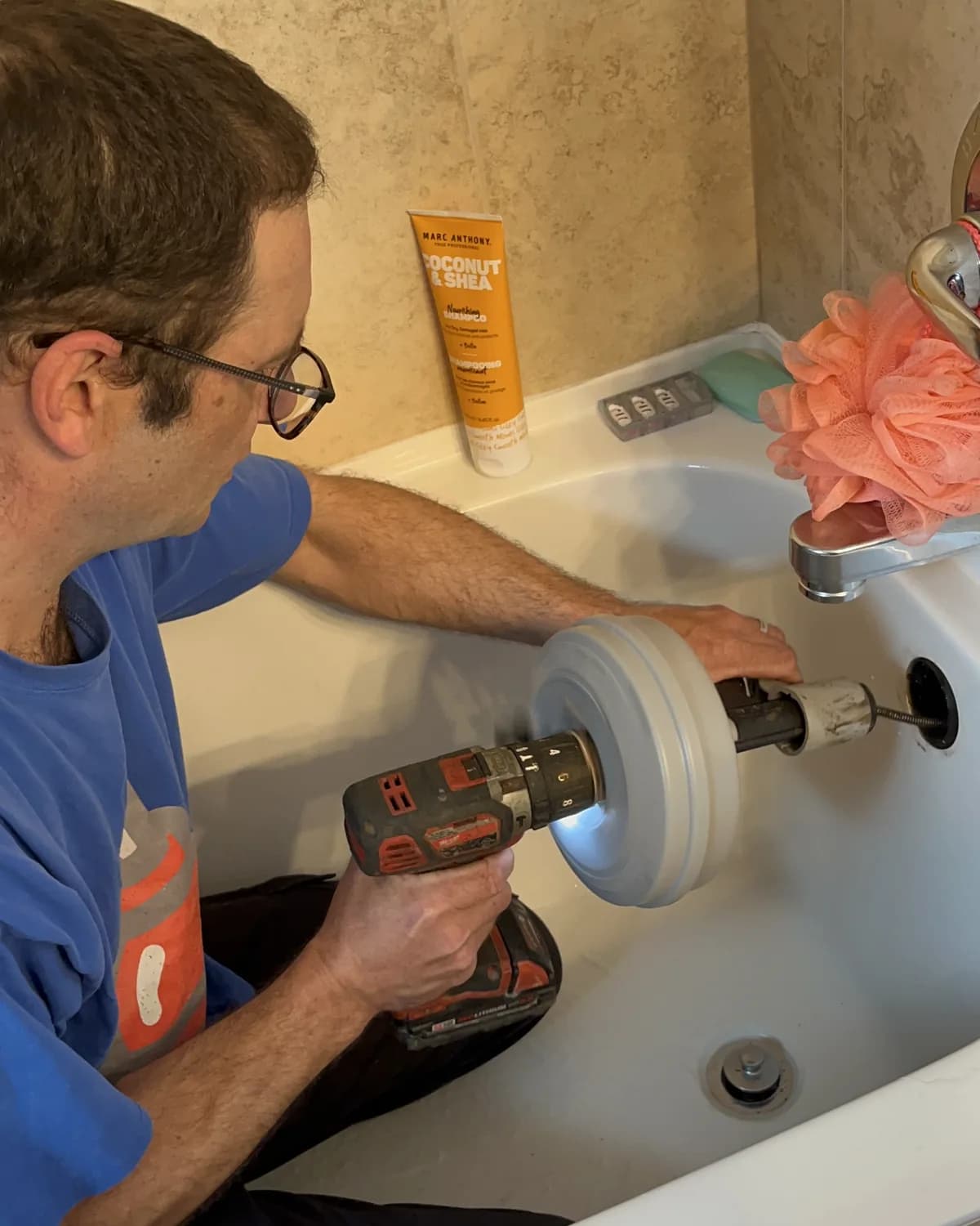 Technician clearing an accessible residential tub drain