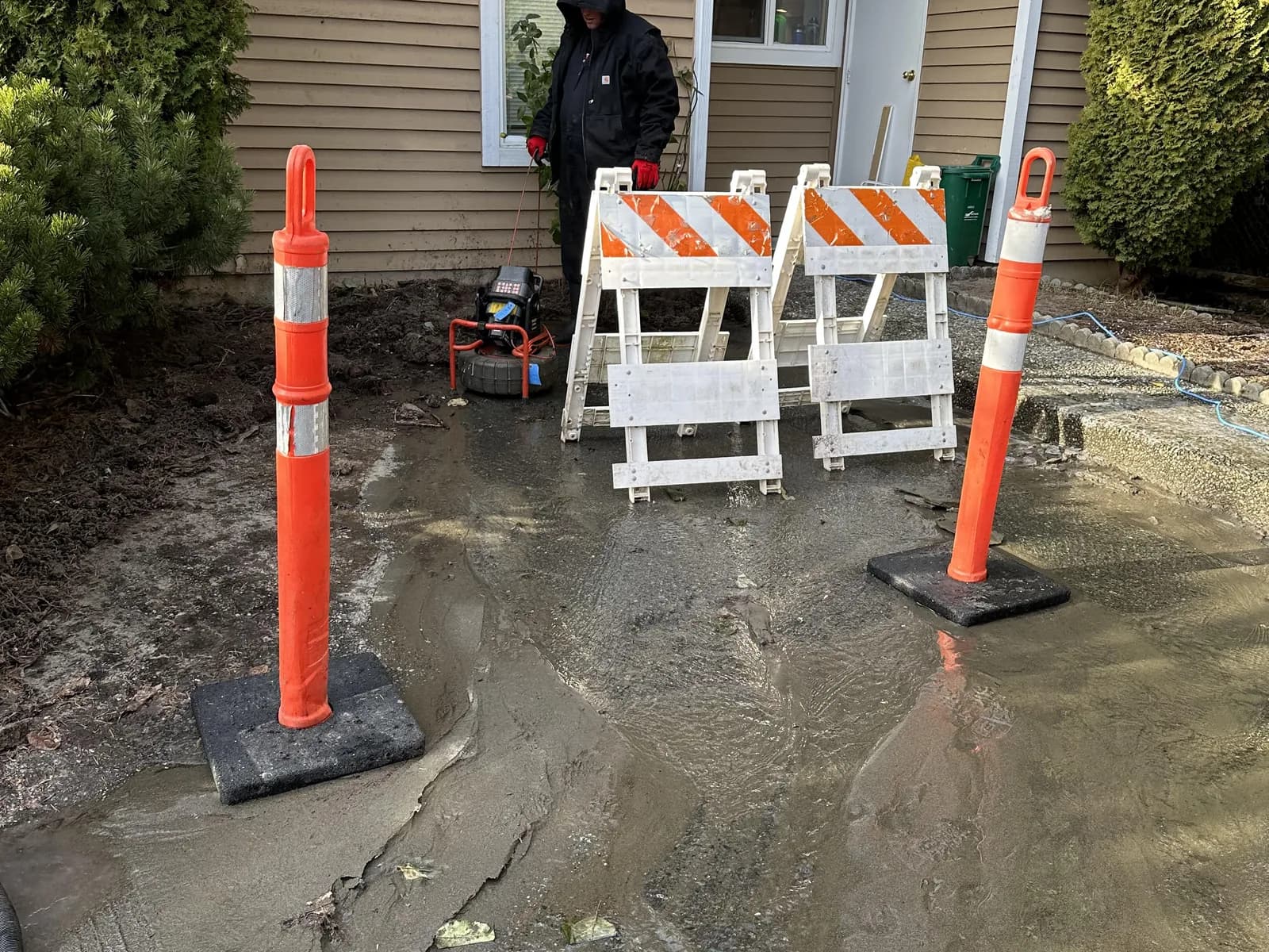 Protected residential excavation area prepared for buried water-service work