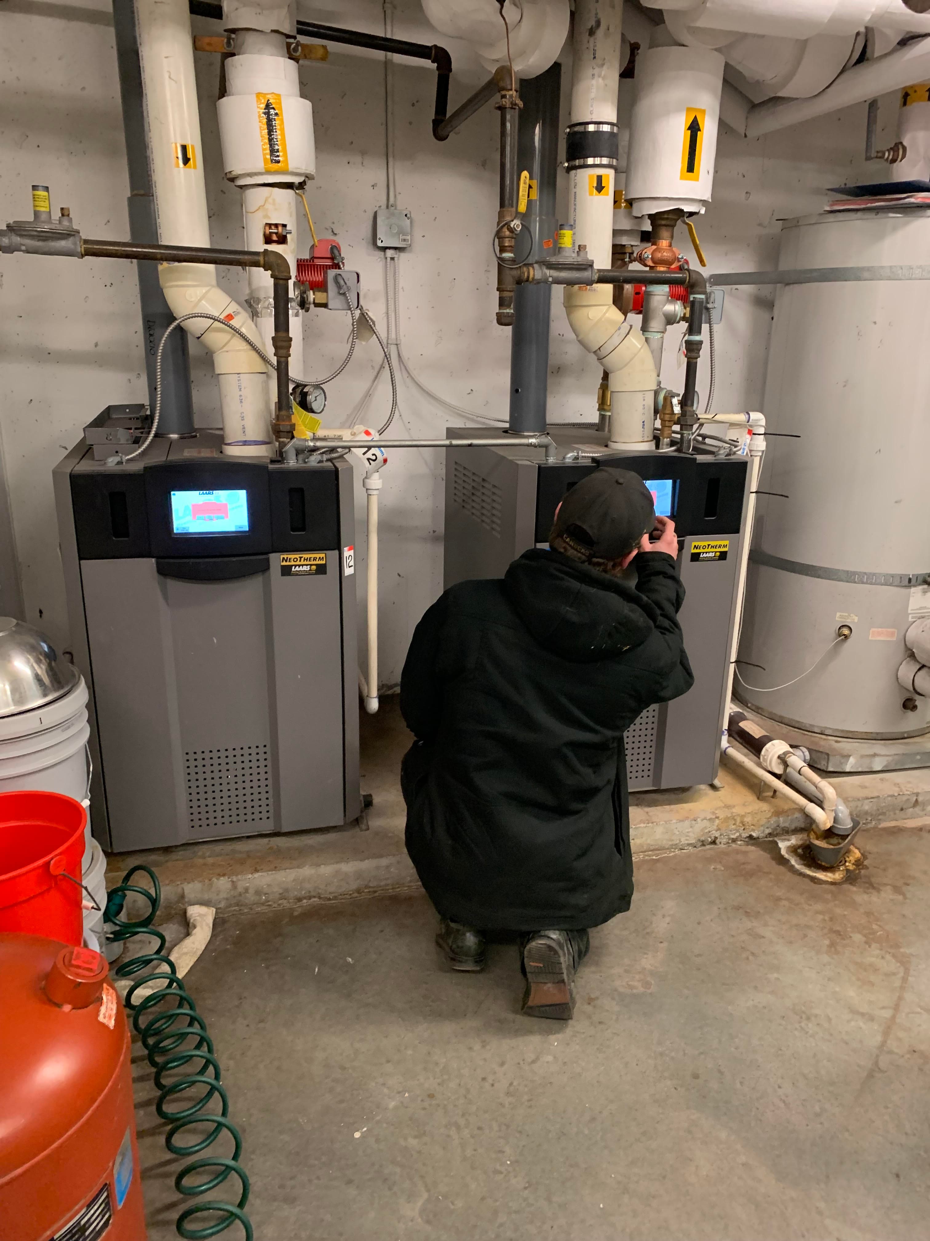 Technician inspecting a boiler room system