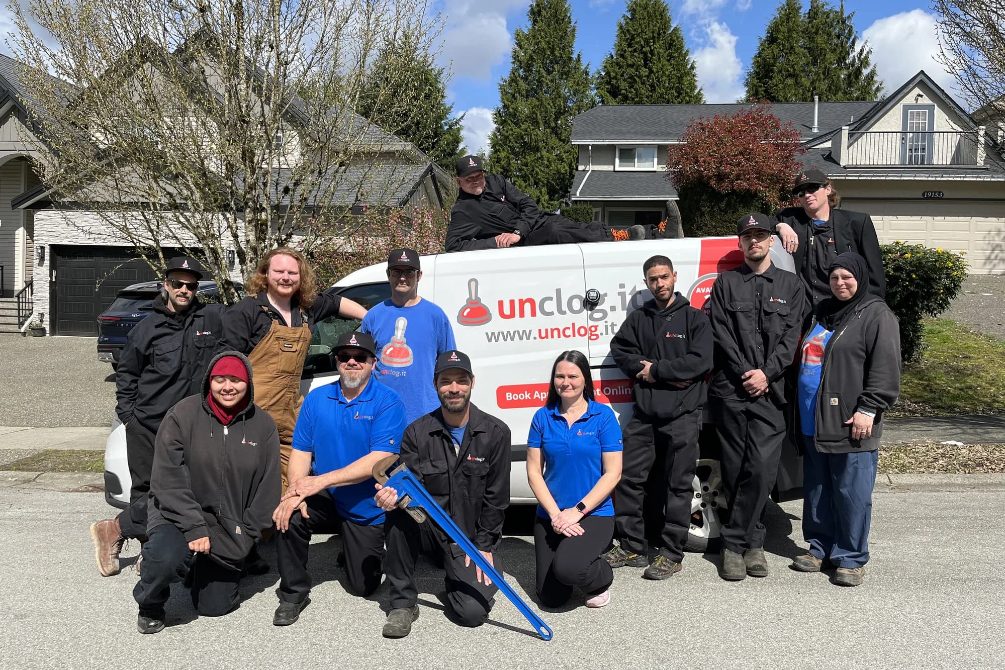 Pure Mechanical Group team members with a branded service vehicle