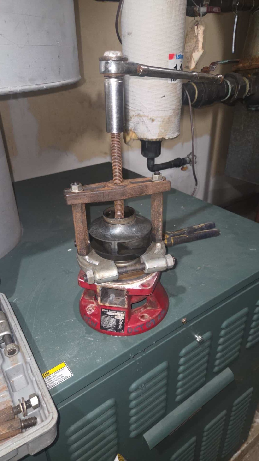 Technician removing the seized impeller from a boiler circulation pump