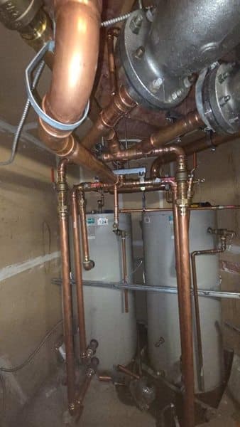 Completed copper distribution piping and valves in a mechanical room