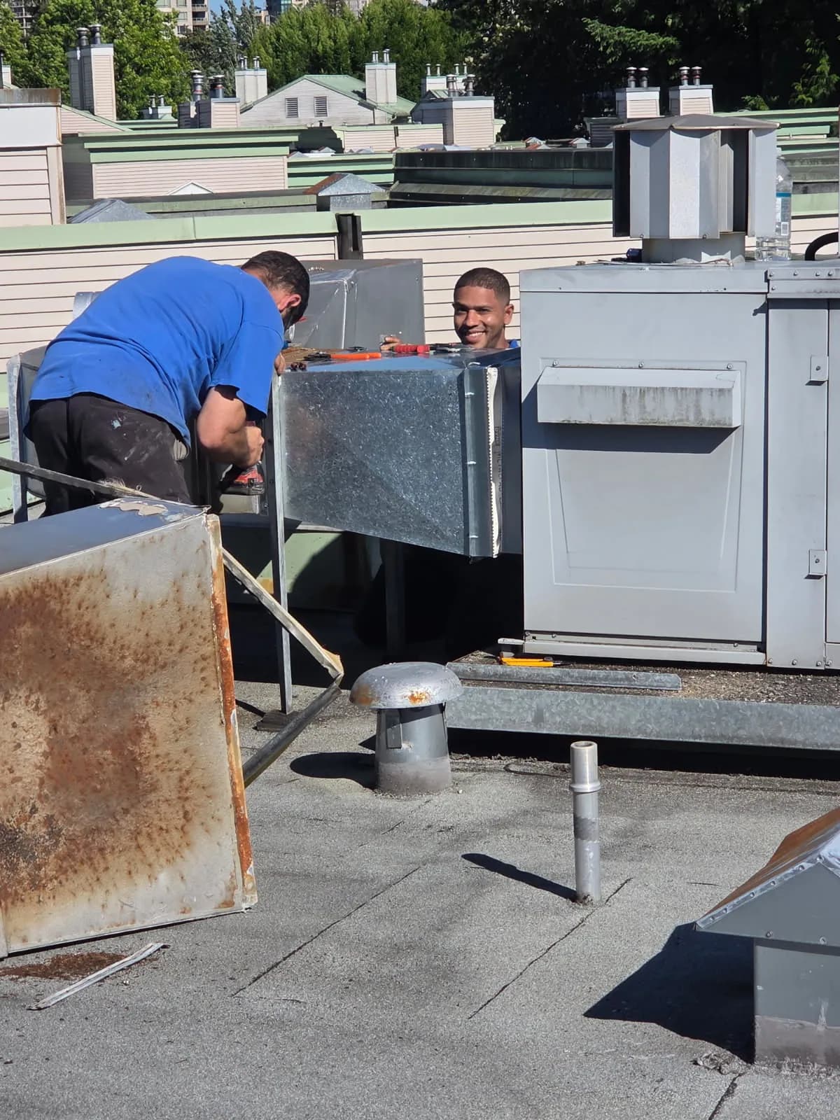 Mechanical technicians working around rooftop equipment