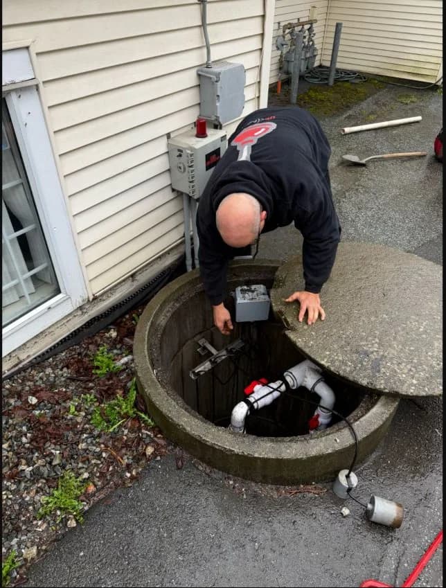 Technician inspecting controls at an open multi-unit storm-sump station