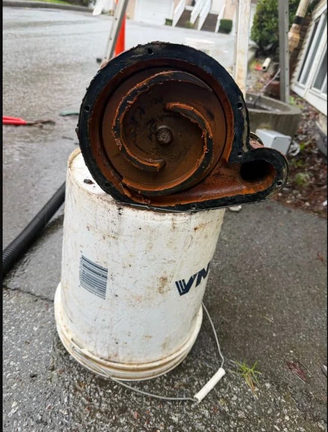 Removed storm-sump pump impeller showing lodged rock debris