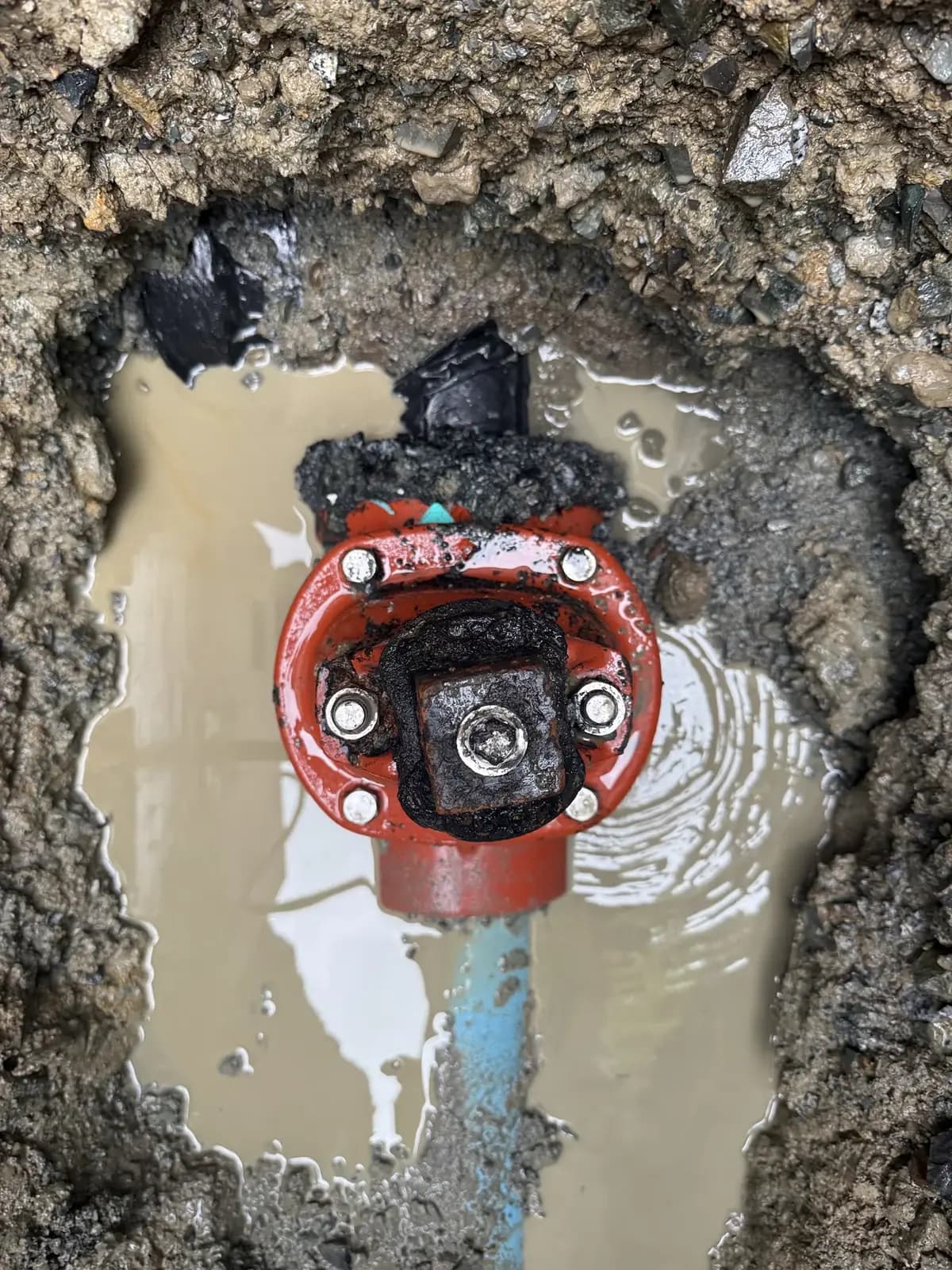Exposed failed underground water-service component during investigation