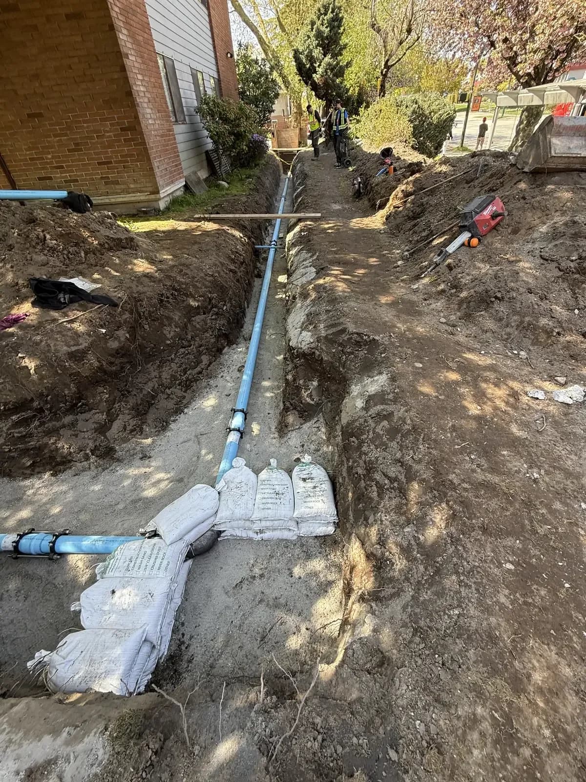 New blue underground water service installed in a prepared trench